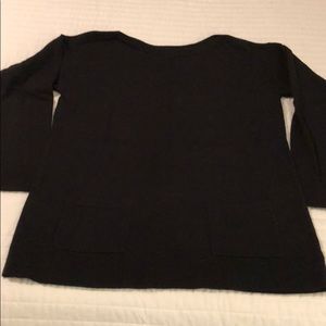 Black sweater with patch pockets.